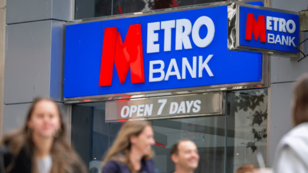Crowd of customers waiting outside a Metro Bank branch due to IT outage, unable to access funds or complete transactions.